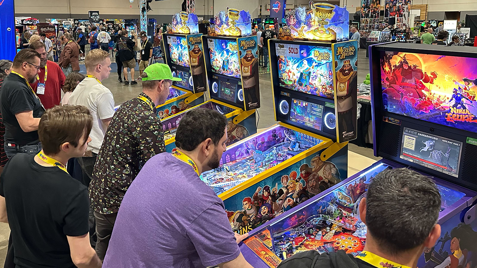 Turner Pinball machines on display at a pinball expo with players engaged